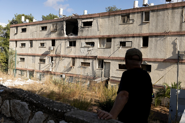 KIRYAT SHMONA, ISRAEL - NOVEMBER 20: A man inspects a damaged building after a rocket was fired from Lebanon in the northern city on November 20, 2024 in Kiryat Shmona, Israel. Israeli Army Radio reported that a rocket fired from Lebanon crashed into the building this morning. (Photo by Amir Levy/Getty Images)