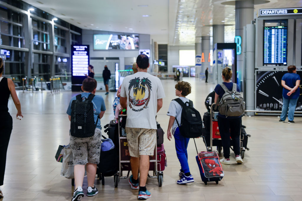 TEL AVIV, ISRAEL - AUGUST 25: Some Israelis and foreign tourists arrive at Ben Gurion International Airport to leave the region, fearing an escalation of tensions and attacks that began early this morning on the Israeli-Lebanese border in Tel Aviv, Israel on August 25, 2024. Israeli warplanes launched over 40 airstrikes on southern Lebanon early Sunday, the most severe attack since cross-border attacks with Hezbollah began last October. The Israeli army claimed that the strikes aimed to prevent an impending Hezbollah attack. (Photo by Nir Keidar/Anadolu via Getty Images)