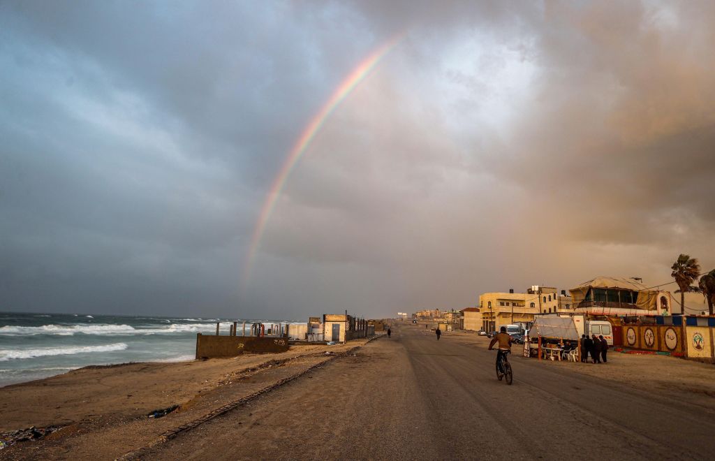 DEIR AL-BALAH, GAZA - JANUARY 11: Rainbow appears over Deir Al-Balah, Gaza following rainfall at the time when the Israeli air strikes decreased amidst Israeli attacks on Gaza on January 11, 2024. (Photo by Ali Jadallah/Anadolu via Getty Images)