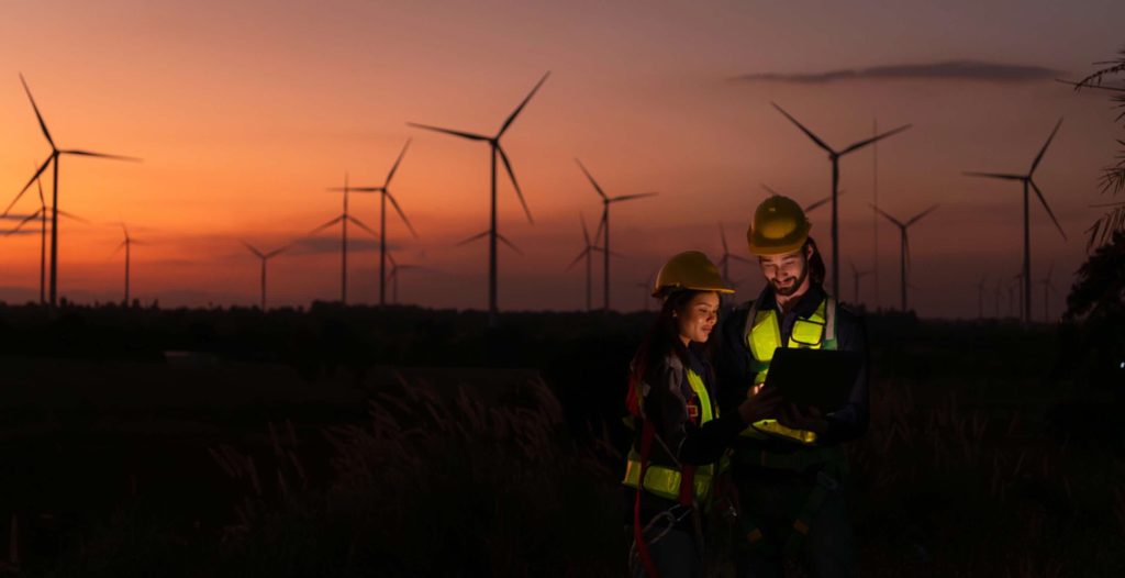 Engineers working on wind turbines farm